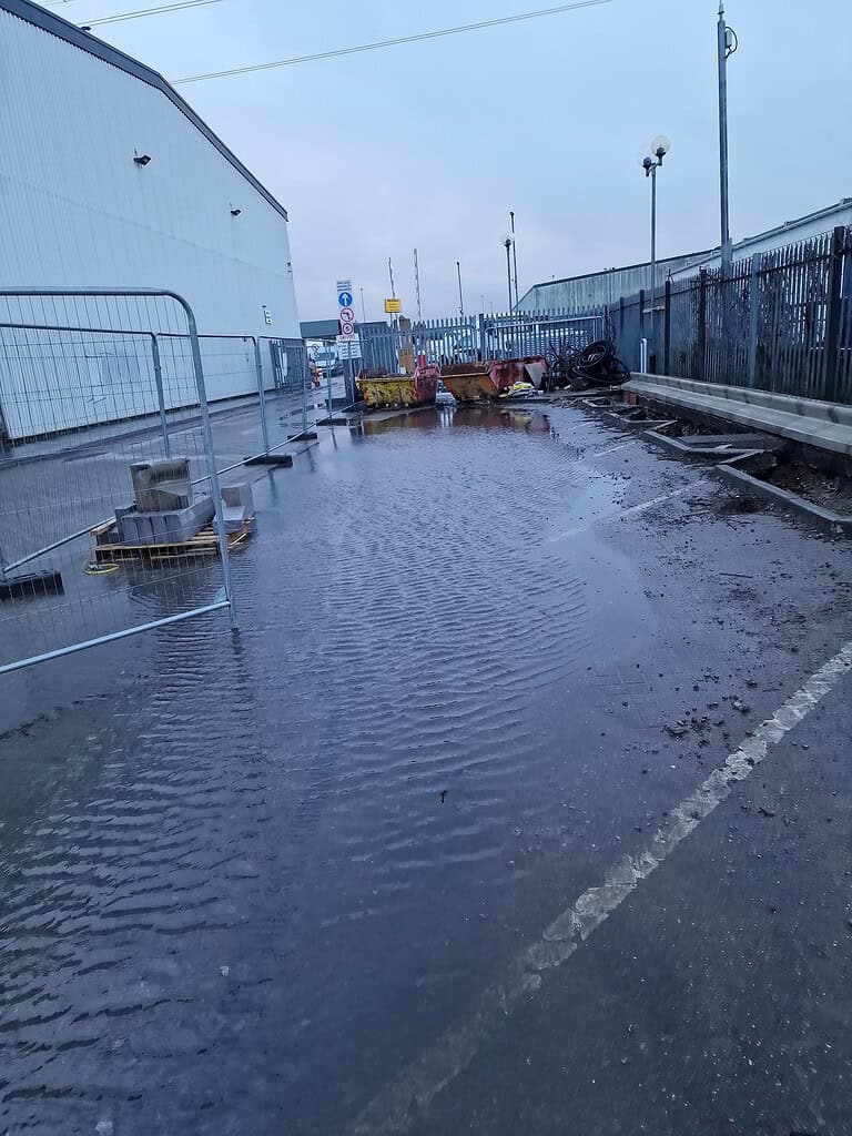 Blocked drainage and water pooling on construction site in UK.