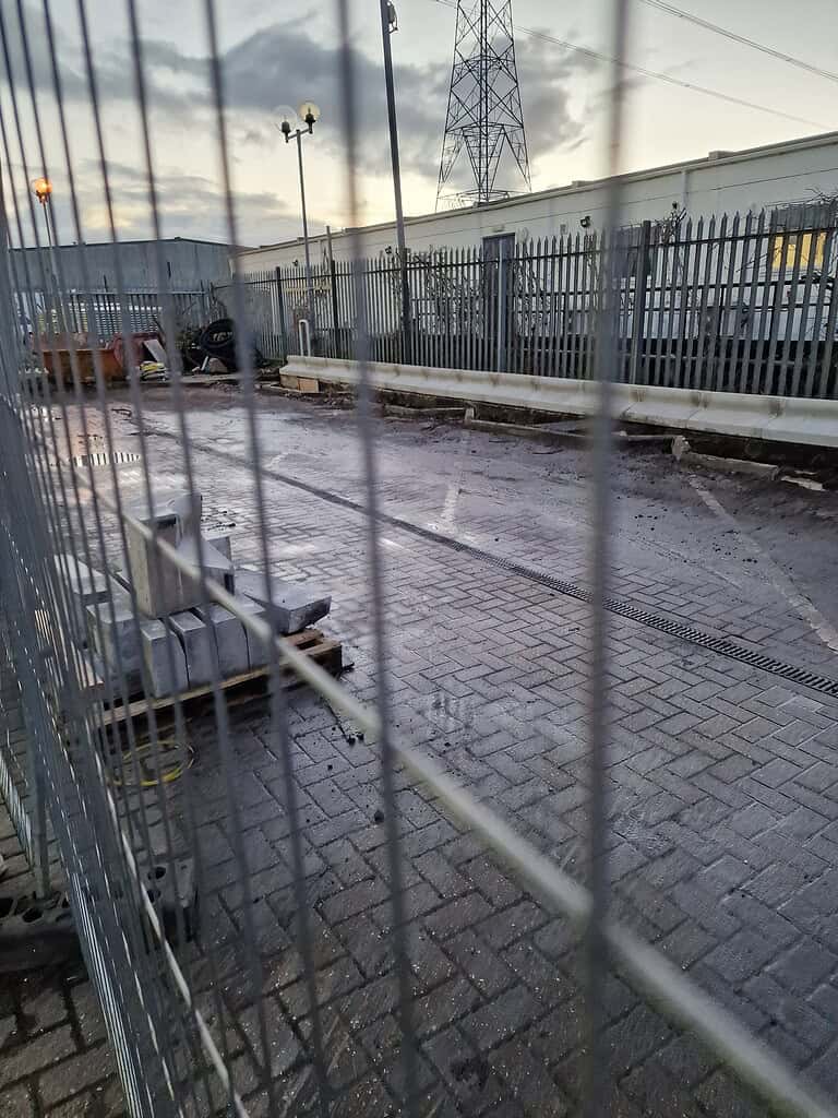 Blocked drainage system installation on industrial site.