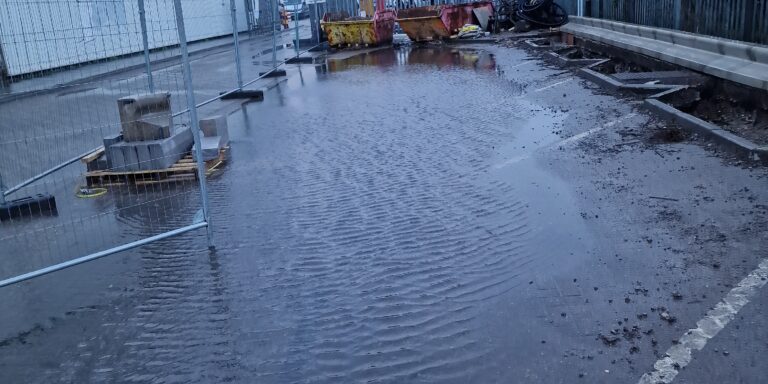 Blocked drainage and water pooling on construction site in UK.