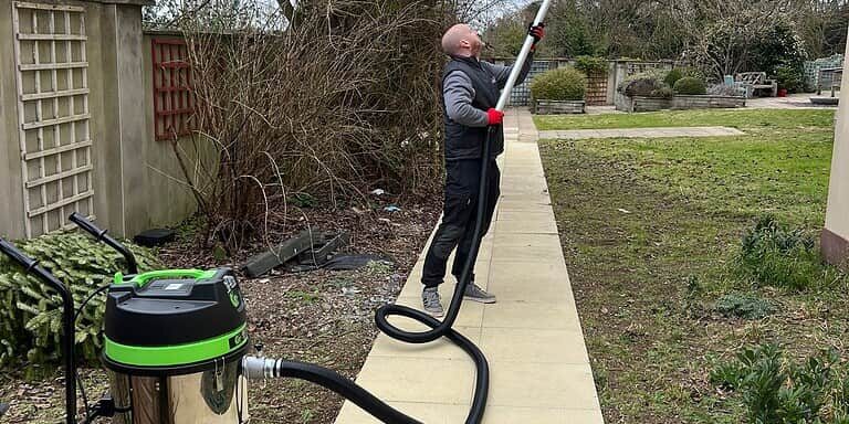 High-pressure drain cleaning using professional equipment for effective blockage removal in outdoor drains.